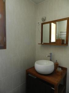 a bathroom with a white sink and a mirror at HERMITAGE in Anzex