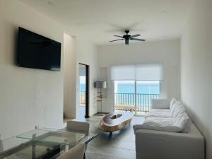 a living room with a couch and a glass table at Brand new penthouse with plunge pool, amazing top view in Isla Mujeres