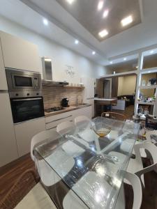 a kitchen and dining room with a glass table at My Dream House 386 in Angri