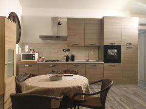a kitchen with a table and chairs and a kitchen with cabinets at Angela's Attic in Voghera
