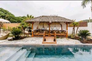 a gazebo sitting next to a swimming pool at Amoremio in Peypin