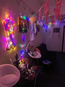 a room with lights on the wall and a room with a table at Sphinx Hostel in Dubai