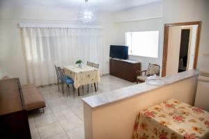 a living room with a table and a dining room at Santis apartment in Areopolis