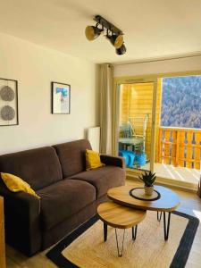 a living room with a couch and a table at Appartement 6 personnes les terrasses d isola2000 in Isola