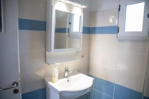a bathroom with a sink and a mirror at Santis apartment in Areopolis +15 photos
