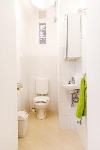 a white bathroom with a toilet and a sink at Authentic Budapest Apartment in Budapest