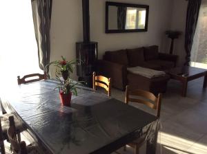 a living room with a table and a couch at Plages débarquements .DDay. Près de Caen in Verson