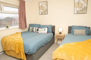 a bedroom with two beds and a window at Contemporary Comfort Trendy Hideaway in Robin Hood