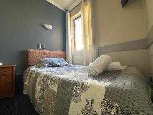 Hotel Vitali في كونثبثيون: غرفة نوم بسرير وبطانية ونافذة