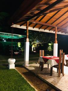 a table and chairs under a gazebo at Villa 252 Kosgoda in Kosgoda