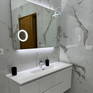 a white bathroom with a sink and a mirror at Villa Manzo-Pompei Vesuvius in Boscotrecase
