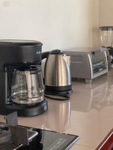 a coffee maker and a toaster on a counter at Villa Del Mar 1 Spectacular ocean view! in Dominical