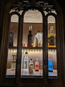 a shelf filled with lots of glass bottles at Le Quai des sorciers 15 minutes de Lille in Haubourdin