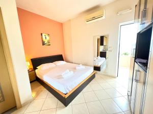 a bedroom with a bed and a bathroom at Ksamil Harmony Studios in Ksamil