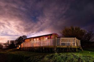 a train car sitting on top of a field at Foxglove Shepherd's Hut in Berwick-Upon-Tweed +9 photos