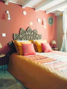 ein Schlafzimmer mit einem großen Bett mit bunten Kissen in der Unterkunft Appartement cosy près de Paris. in Livry-Gargan