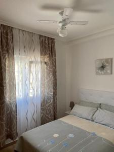 a bedroom with a bed and a window at Punta Prima Gataway in Torrevieja +61 photos