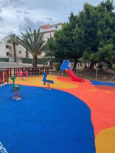 a play area with a playground with a slide at Punta Prima Gataway in Torrevieja