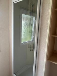 a shower with a glass door in a bathroom at Decker’s in Leven-Fife