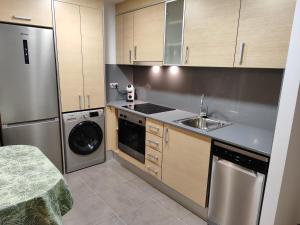 a kitchen with a sink and a dishwasher at La Barcassa de Deltebre in Deltebre