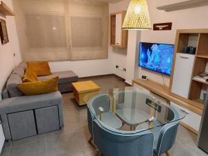 a living room with a couch and a tv at La Barcassa de Deltebre in Deltebre