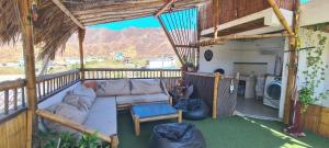 a living room with a couch on a porch at Casa Piscis Spa in Taganga