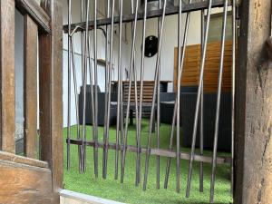a iron fence with a table and chairs behind it at F2 hyper centre ville Lons in Lons-le-Saunier