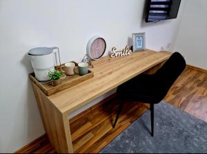 a wooden desk with a chair and a mirror at Infinity Apartment & Free Wifi & Free Parking in Sarajevo