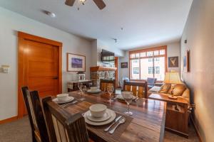 a dining room and living room with a wooden table at 589- Village 1Bed 1Bath Condo with Pool Spa and Walk to Gondola in Mammoth Lakes