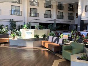 a lobby with couches and plants in a building at Best Western Royal Plaza Hotel and Trade Center in Marlborough