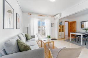 a living room with a couch and a table at Casa Del Sol in Gran Alacant