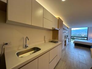 a kitchen with a sink and a large window at Increible apartamento cerca de Centro Chia y U Sabana in Chía