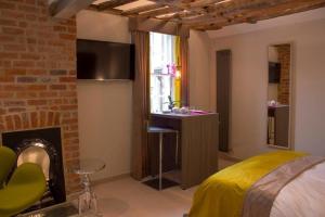 a bedroom with a bed and a table and a fireplace at Henry's in Oxford