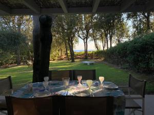 a table with plates and wine glasses sitting on a patio at Cala dei Pirati in Punta Ala