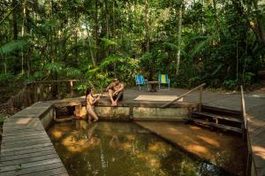 a man and a woman sitting in a pool of water at Aconchego Gaia in Alter do Chao