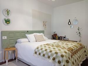 um quarto com uma grande cama branca e uma cabeceira verde em LA MACETA em Vilagarcía de Arousa