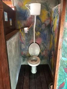 a bathroom with a toilet with a painting on the wall at Aconchego Gaia in Alter do Chao
