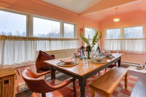 a dining room with a table and chairs and windows at Wantage Getaway with Private Pickleball Court! in Wantage