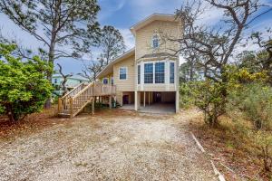 a large house with a porch and a staircase at Sandy Feats in Gulf Highlands