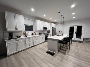 a large kitchen with white cabinets and a kitchen island at Sunset Haven in Front Royal