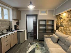 ein Wohnzimmer mit Sofa und eine Küche in der Unterkunft Mrassi in Palermo