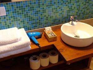 y baño con lavabo y toallas sobre una mesa de madera. en Casas con vista al Piltri en El Bolsón