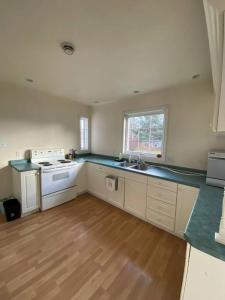 a kitchen with white appliances and a wooden floor at Amy's house in Charlottetown