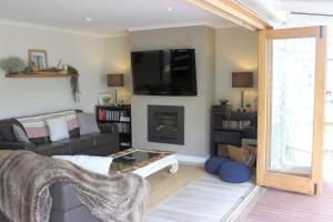 a living room with a couch and a fireplace at Palm Breeze at Sunset Strip in Sunset Strip