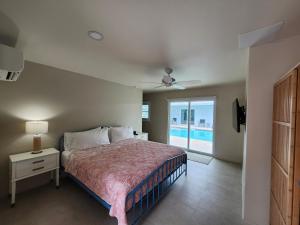 a bedroom with a bed and a view of a pool at Sunshine Island Inn in Sanibel