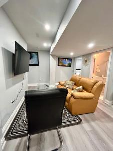 a living room with a couch and a television at APARTMENT B 2 BEDROOM in Brampton