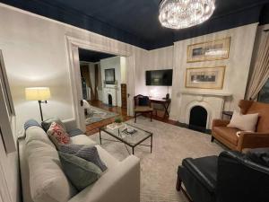 uma sala de estar com um sofá e uma lareira em Charming Historic District Parlor Level Apartment em Savannah