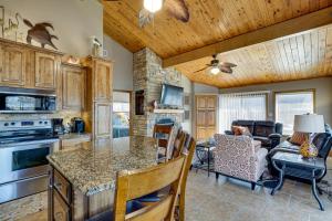 a kitchen and living room with a table and chairs at Private Dock Lakefront Sunrise Beach Home in Sunrise Beach