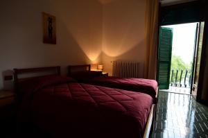 a bedroom with two beds and a large window at Hotel La Silvana in Selva di Fasano