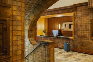 a lobby with an archway in a brick wall at Sonder The Craftsman in Los Angeles